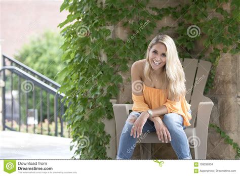 Stunning Young Blonde Woman Poses In Orange Blouse Stock Photo Image