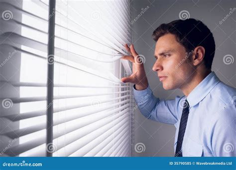 Businessman Peeking Through Blinds In Office Stock Image Image Of
