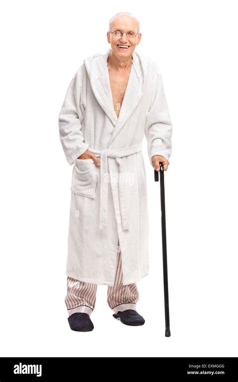 Full Length Portrait Of A Senior Man In A Bathrobe Holding A Cane And Looking At The Camera