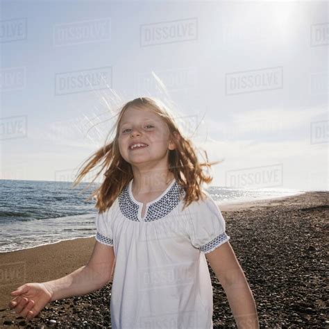 Girl At Beach Smiling At Camera Stock Photo Dissolve