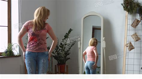 Woman Struggling Trying To Fit Into Tight Jeans Stock Video Footage