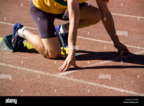 Male Athlete In Starting Blocks On A Running Track Stock Photo Alamy