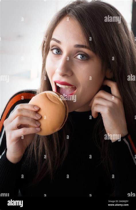 Girl At Fast Food Restaurant While Eating A Hamburger Stock Photo Alamy