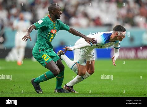 Phil Foden Of England And Youssouf Sabaly Of Senegal During The Fifa