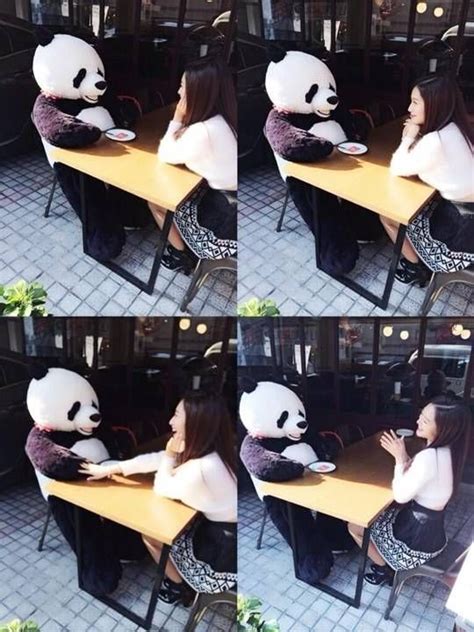 There Is A Woman Sitting At A Table With A Stuffed Panda Bear On Her Lap