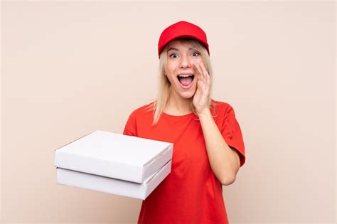 premium photo pizza delivery russian woman holding a pizza over isolated wall shouting with