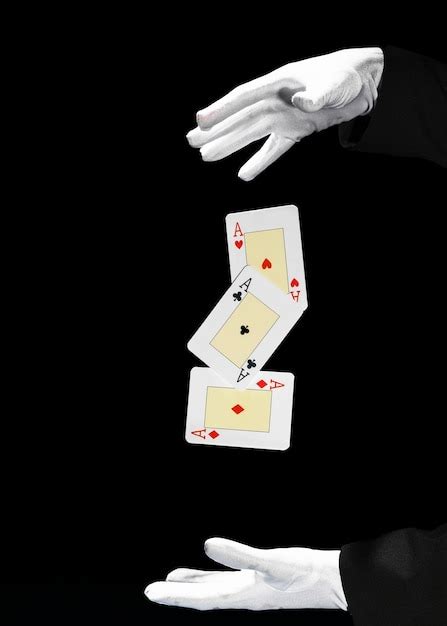 Premium Photo Magician Performing Playing Card Trick Against Black