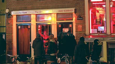 amsterdam netherlands december 27 2017 tourists walk by prostitutes rooms in famous red