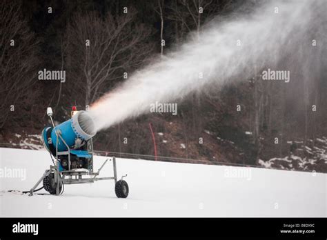 Snow Making Machine Throwing Plume Of Artificial Snow Onto On Piste In