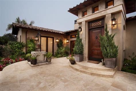 Italian Villa Front Entry Courtyard With Neutral Stone Tile Leading To