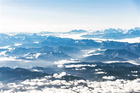 Landscape Aerial View Of Blue Alps Mountains With Clouds Above