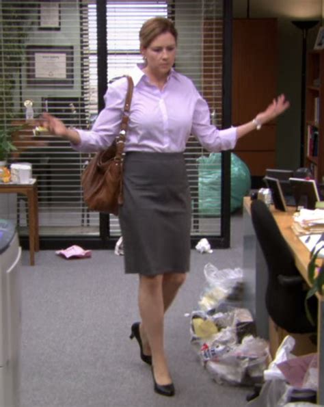 A Woman Is Walking In An Office With Her Hand Out To The Side And Shes Wearing A Skirt