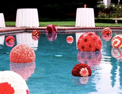 Pool decorations can be fun and funky or chic and elegant by create wedding pomanders by inserting fresh or silk flowers, one by one, and tightly together into large styrofoam balls. Flower Balls in the Pool | Wedding flowers, Pool wedding