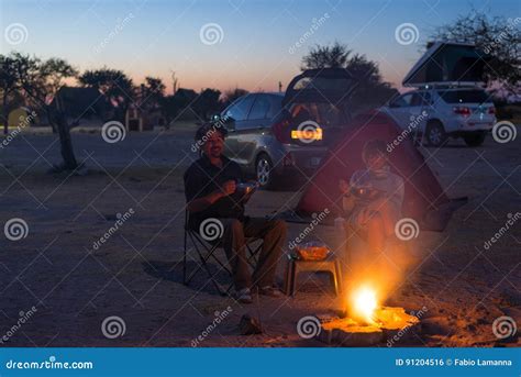 Adult Couple Relaxing In Camping Site By Night Adventure In National Park South Africa Stock