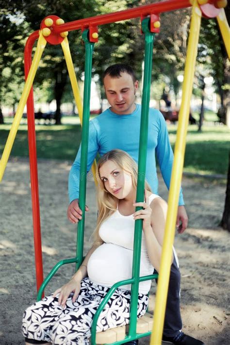 Dad Having Fun Pregnant Wife In The Park During Stock Photo Image Of