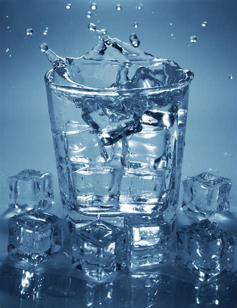 Premium Photo Pouring Ice Cube Into Drink Glass Of Water Splashing