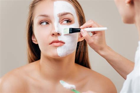 Spa Therapy For Young Woman Receiving Facial Mask At Beauty Salon