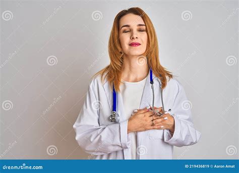 redhead caucasian doctor woman wearing stethoscope over isolated background smiling with hands
