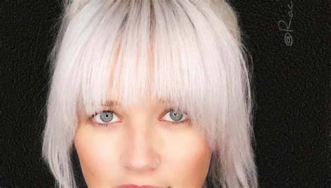 Large Messy Top Bun With Full Face Framing Fringe And Platinum Blonde