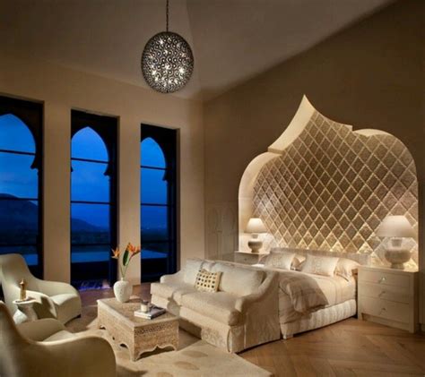 An Elegant Bedroom With Large Windows And White Furniture