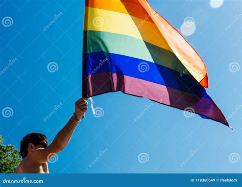 Caucasian Excited Gay Man Waving Rainbow Flag At Pride Editorial Stock