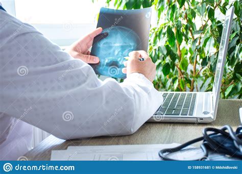 Doctors should start by considering a computer's location in the office. Doctor In Office Near Computer Considers And Examines X ...