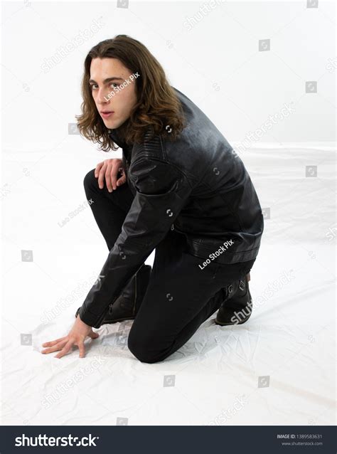 Brooding Young Man Black Leather Crouching Stock Photo 1389583631