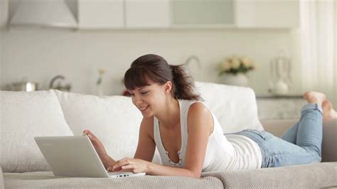 Woman Using Laptop Smiling On Couch Stock Footage Sbv 303984448 Storyblocks