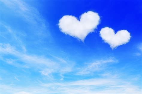 Two Heart Shaped Clouds On Blue Sky For Valentine Background Stock