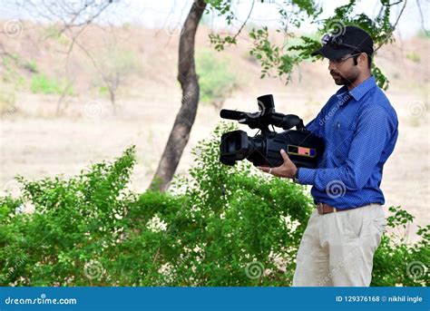 Cameraman Using A Professional Camcorder Outdoor Filming Documentary