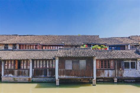 Traditional Chinese Houses By Water Under Blue Sky In The Old Town Of