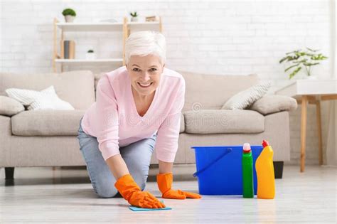 Smiling Mature Housewife Cleaning Floor At Home Stock Image Image Of