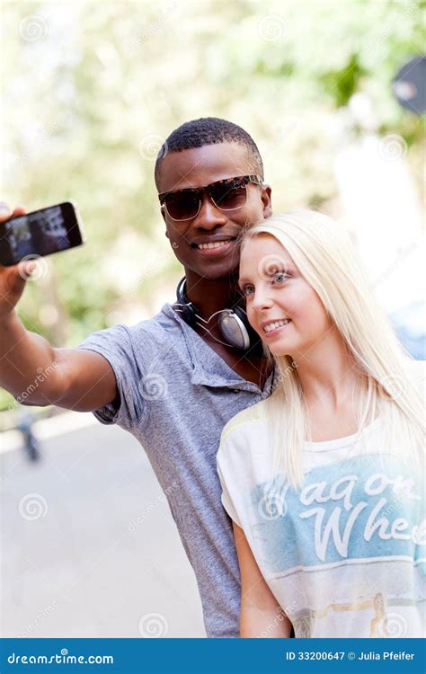 Young Smiling Multiracial Couple Taking Foto By Smartphone Stock Image Image Of Caucasian