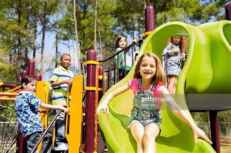 Elementary Children Play At School Recess Or Park On Playground High
