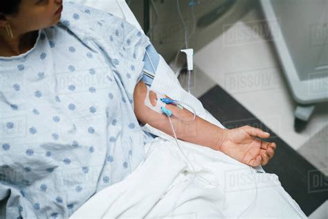Tubes In Arms Of Patient In Hospital Bed Stock Photo Dissolve