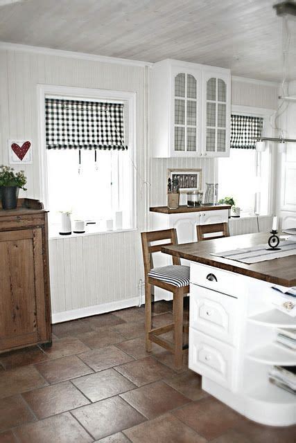 See these ideas on how to make white kitchen cabinets work in your own design. white kitchen, tile floor in a dark color, love the wood ...