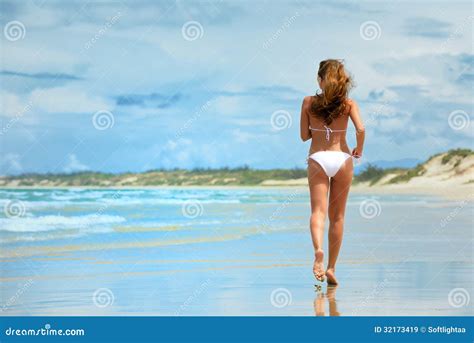 A Woman Running Along The Beach In A White Bikini Stock Image Image Of Desire Route