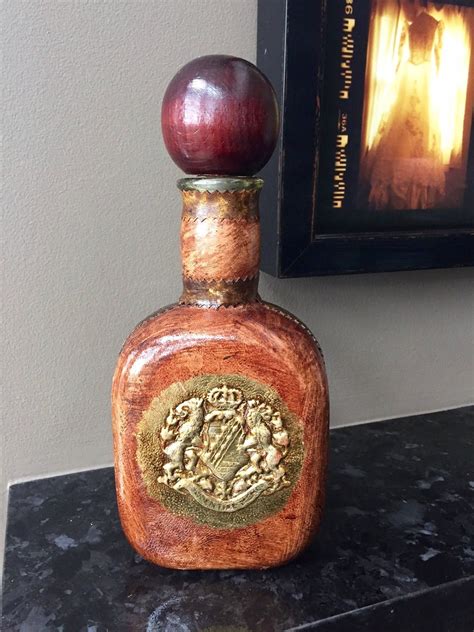 This Leather Wrapped Liquor Bottle Decanter Lantern Metal Crossed