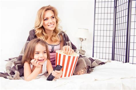 Excited Mom And Daughter Watching Tv And Eating Popcorn Stock Photo Image Of Love Morning