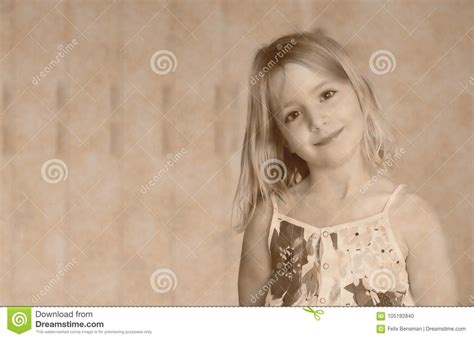 Six Year Old Blonde Girl In A Summer White Dress With Flowers Smiling