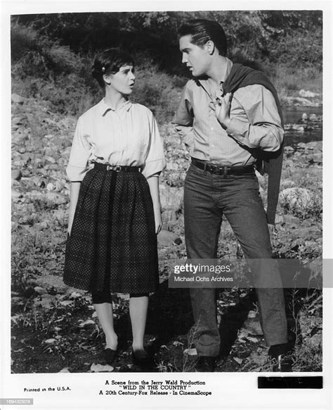 Millie Perkins And Elvis Presley Walking Outside In A Scene From The