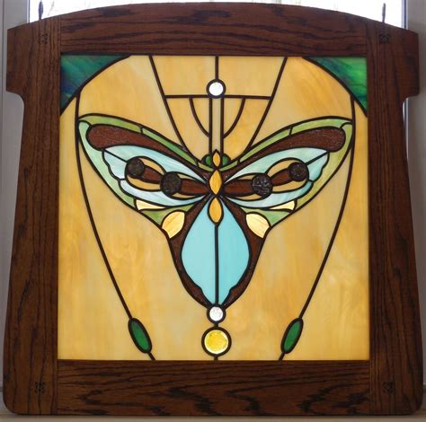 hand crafted stained glass panel art deco butterfly framed in oak by judi cahill stained glass
