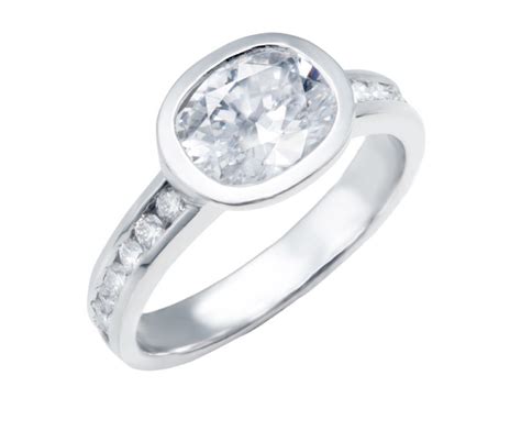 Bezel Set Oval Diamond Engagement Ring With Round Diamond Accents