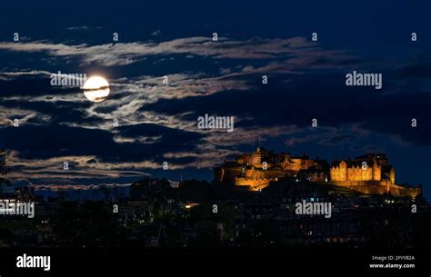 A Full Moon Supermoon Rising Above The Capital Citys Lit Up Landmark