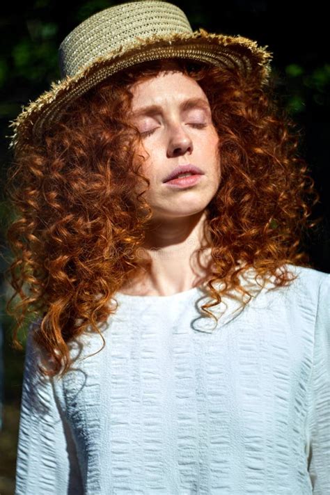 Portrait Of Tender Caucasian Redhead Female With Curly Wavy Hair Posing With Eyes Closed Stock