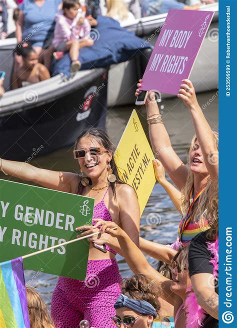 close up people at the amnesty international boat on the at the gaypride canal parade with boats