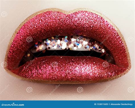 glamour fashion bright red lips make up with glitter macro of woman`s face part glossy lip