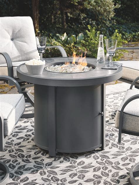 Donnalee Bay Dark Gray Round Fire Pit Table Ez Furniture Sales