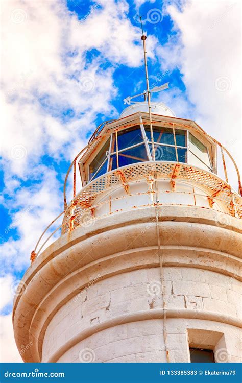 White Lighthouse Against Blue Sky With Clouds Stock Image Image Of