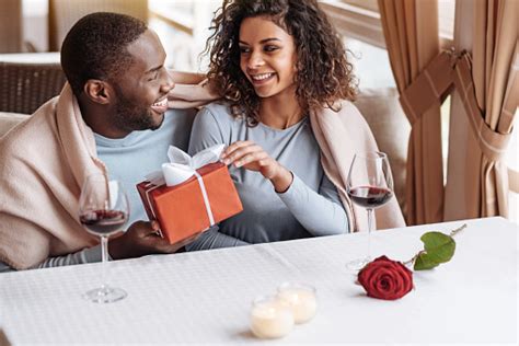 Delighted African American Man Giving The Box To His Girlfriend Stock